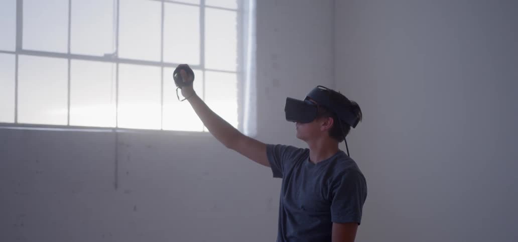 A man uses a vr headset in an empty room