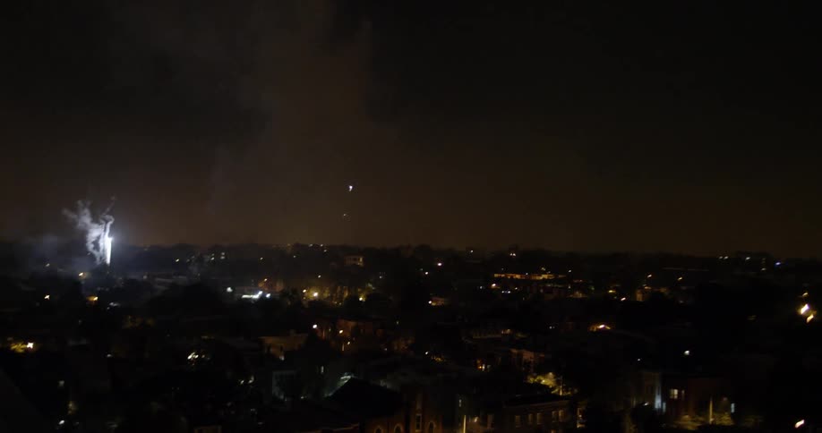 Fireworks in the night sky over a city