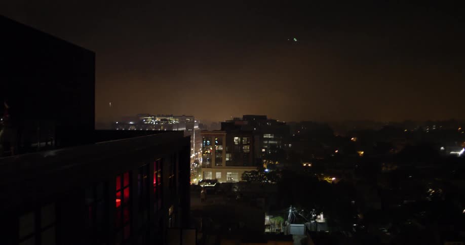 Fireworks explode in the dark sky over the city