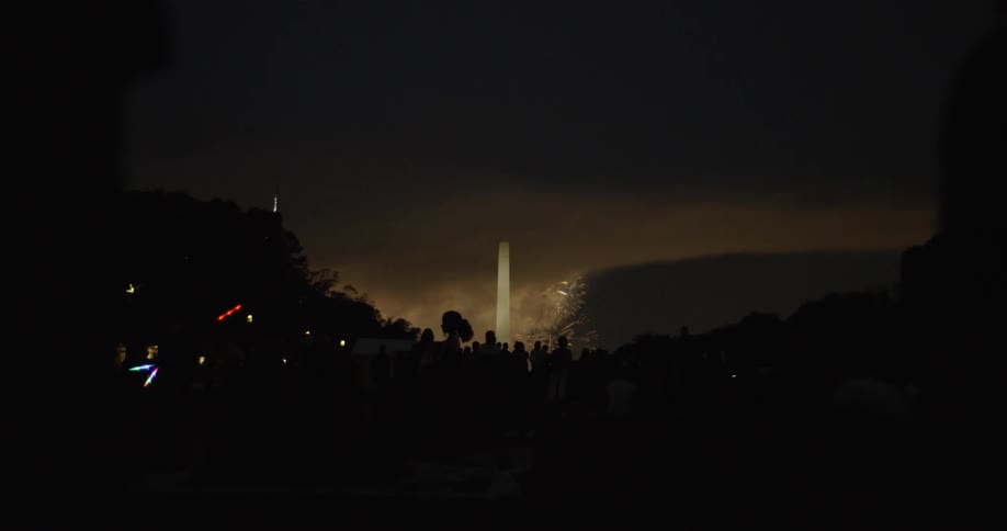 People gather on the national mall near the washington monument to watch the fireworks