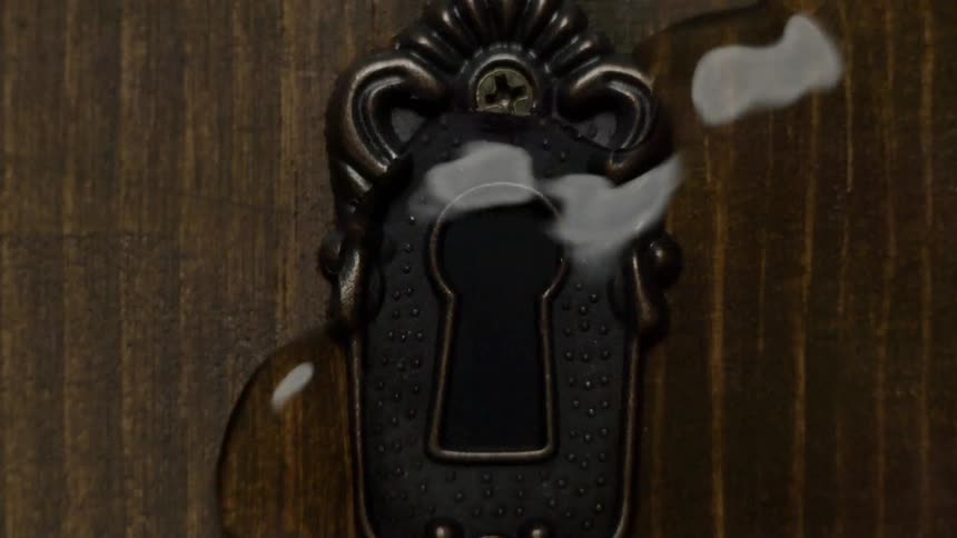 Water begins pouring out of a keyhole