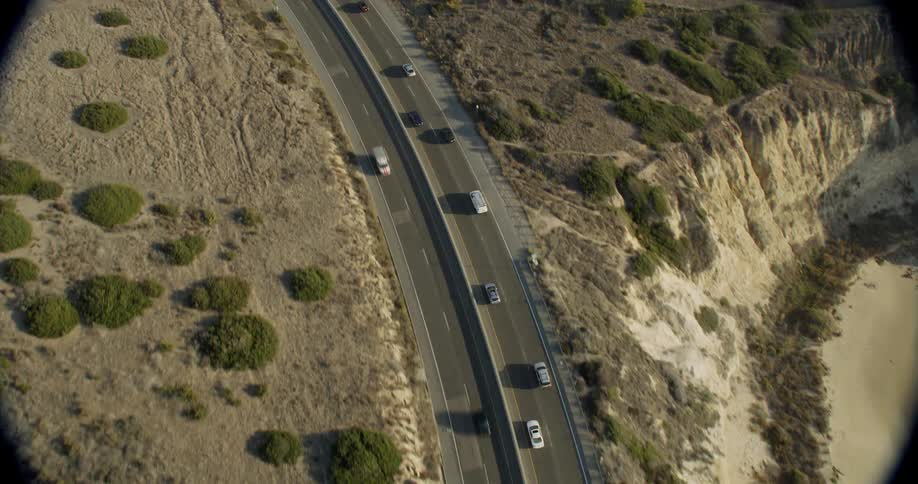 Vehicles travel on the coastal road