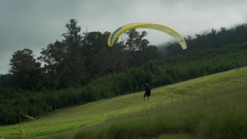 Parachuter comes in for landing in field