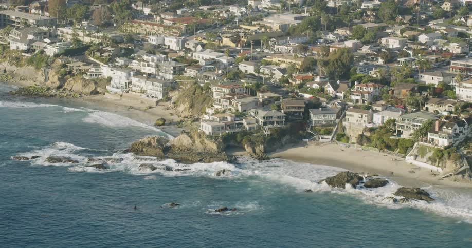 Waves crash into shore near the buildings