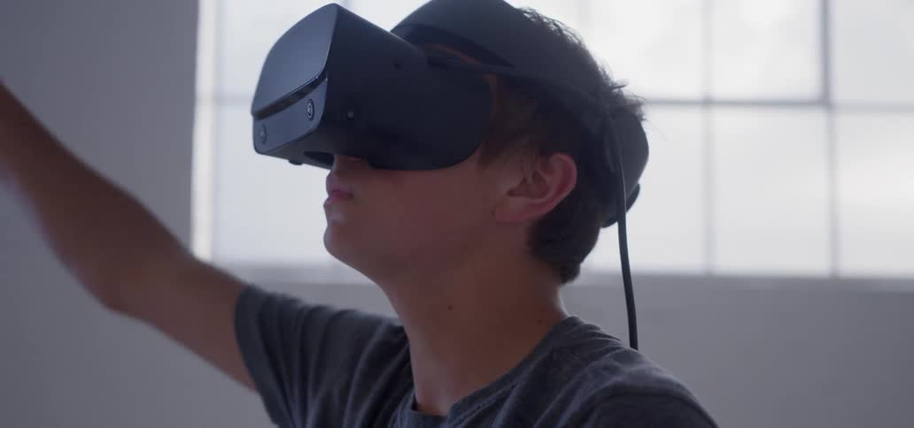 A young man plays with a vr headset