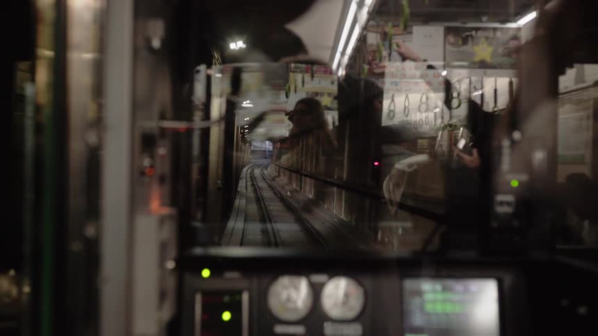 A commuter train travels on the tracks