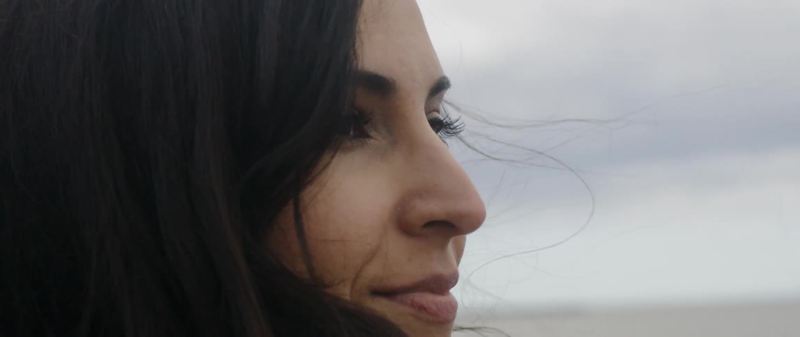 Woman blinks as her hair blows in the breeze