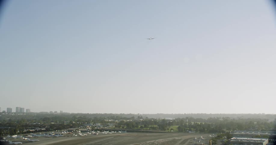 An airplane flies over a city on a clear day