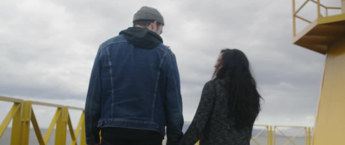Man and woman walk up a concrete staircase