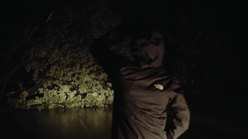 Man wearing a jacket walks in the dark