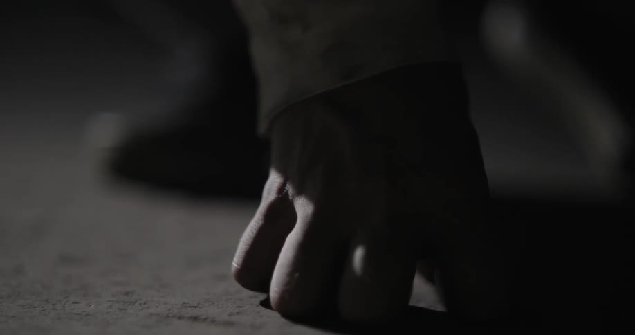 A person rests their knuckles on the ground