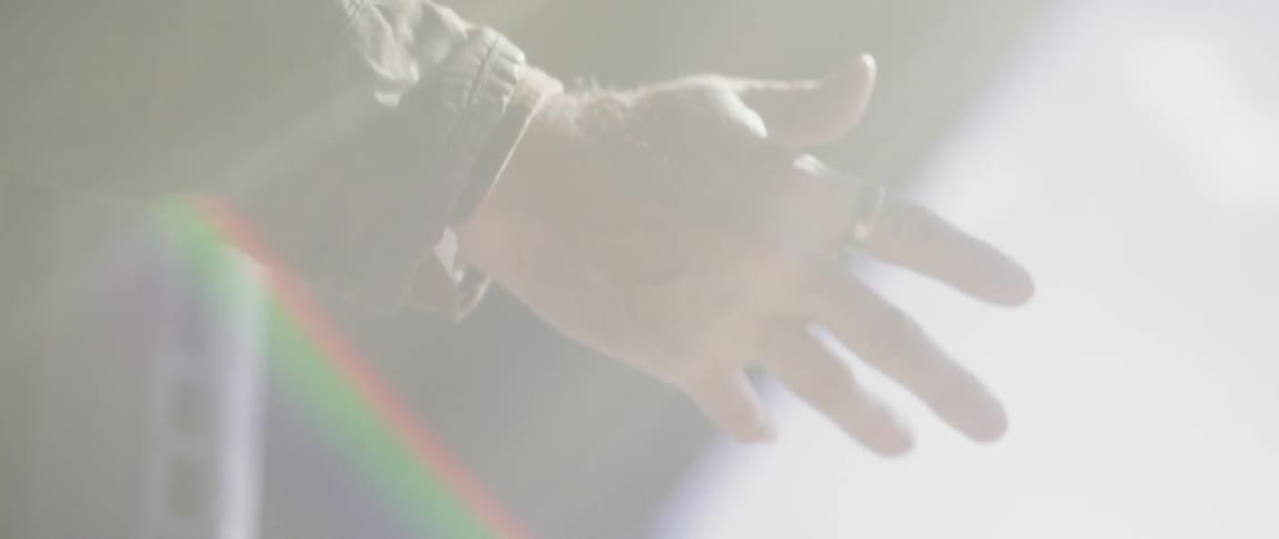 A man reaches out his hand on a sunny day