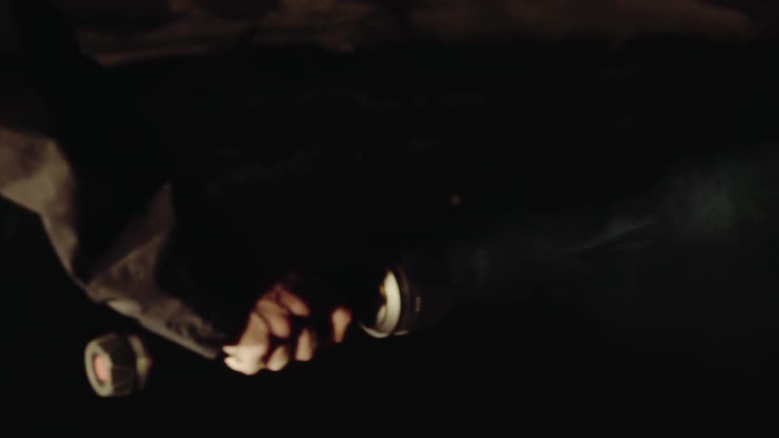 Hand with Flashlight in the Rain