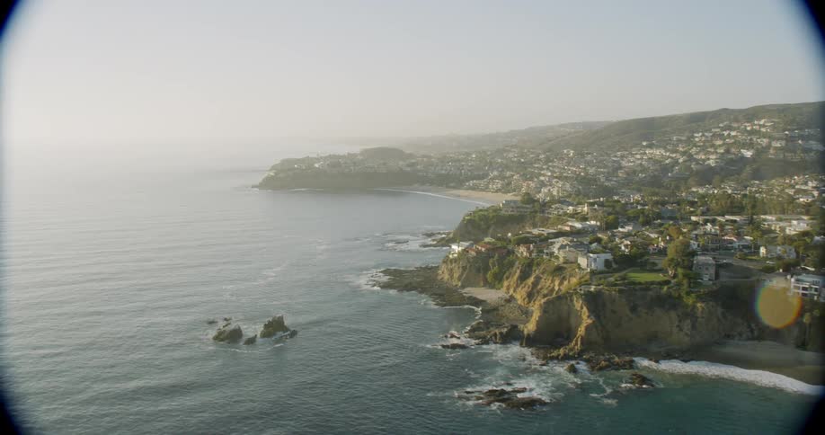 The waves crash against the town on the coast