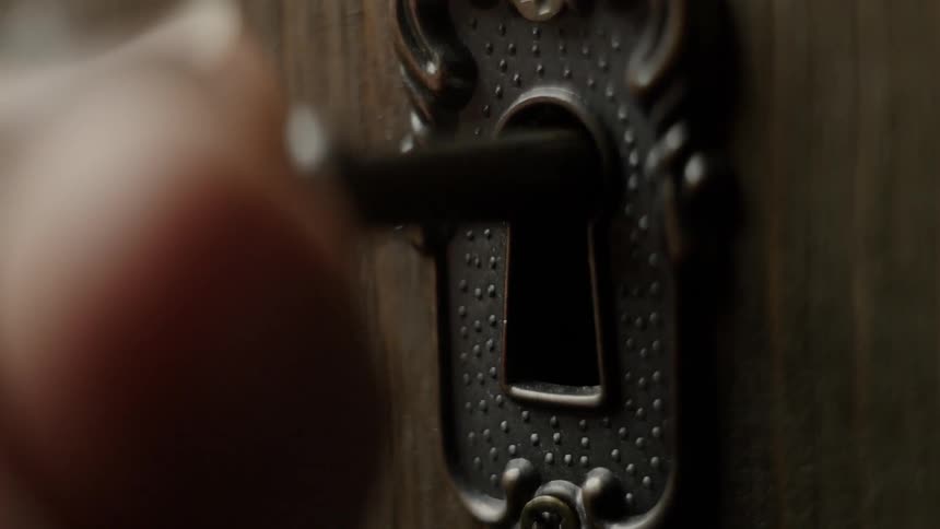 A person turns the key in the lock