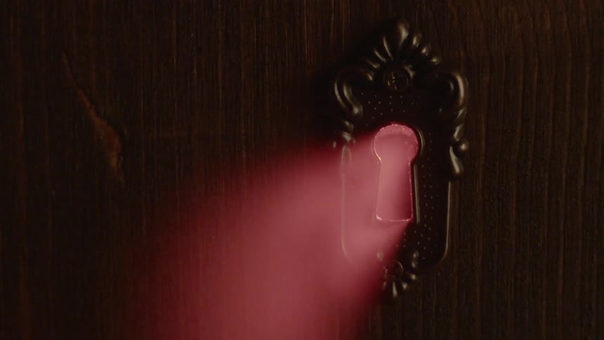 Red light shines through the keyhole