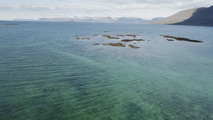 The clear water shows the rocks underwater