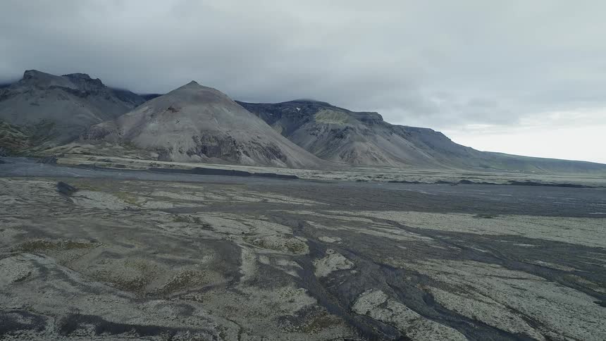 The hills lead to a cloud covered mountain
