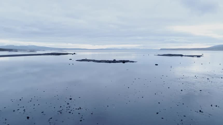 The rocks sit in the still waters