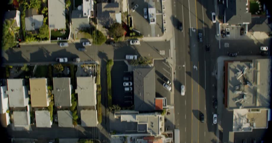 Cars drive on a city street