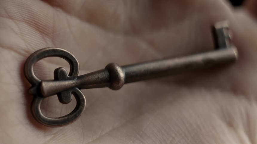 Hand opens and there is a key in it