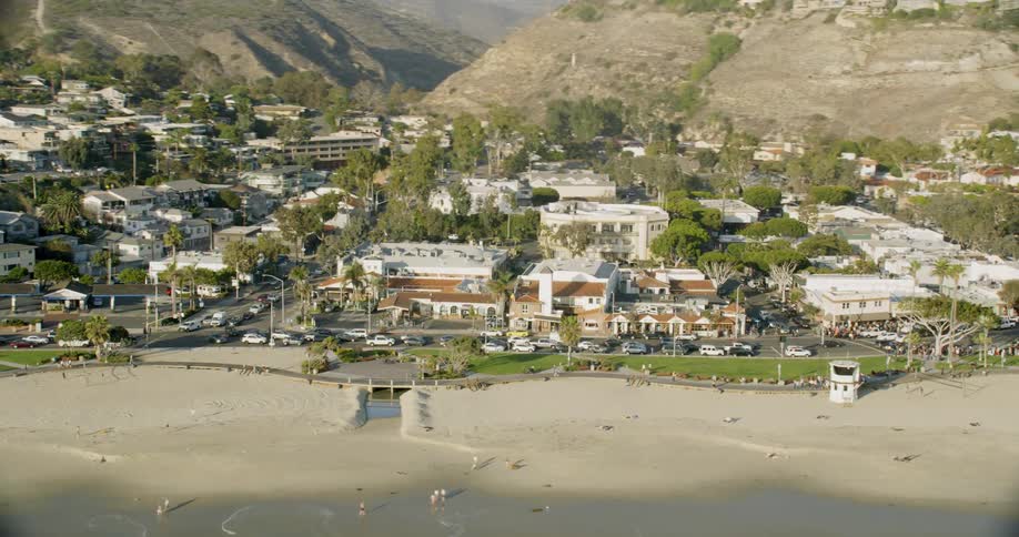 The coastal town has hills behind it