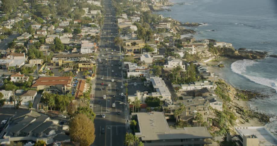 Cars drive in a coastal town