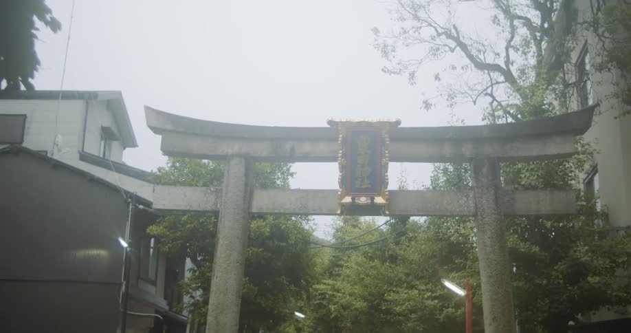 Rectangular sign sits at the top of an entryway to a garden