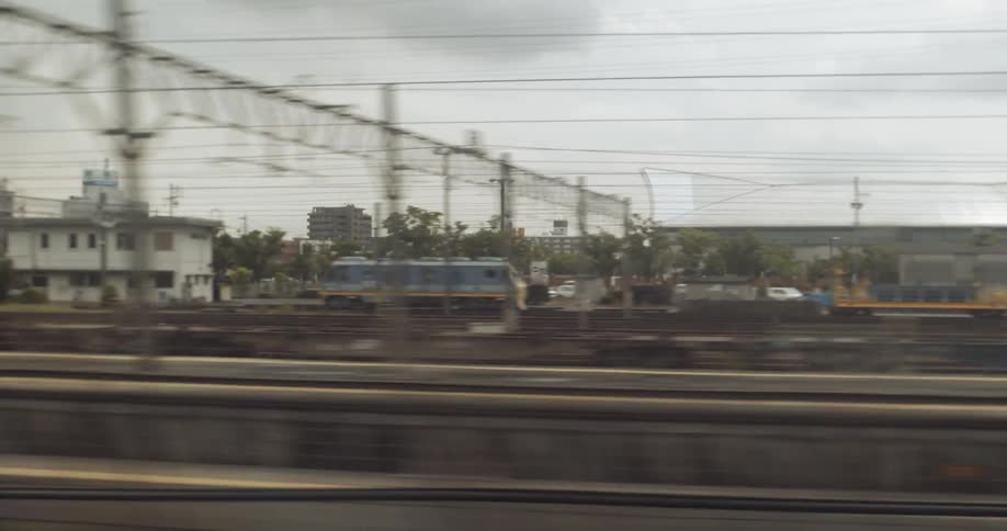 The train is moving down the tracks on a cloudy day