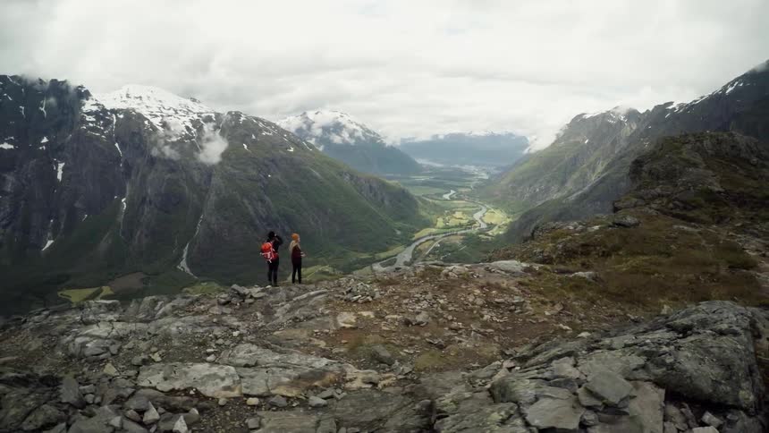 Two people look out over a large canyon