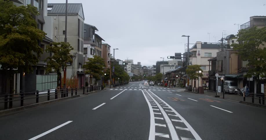 Cars drive on a city street