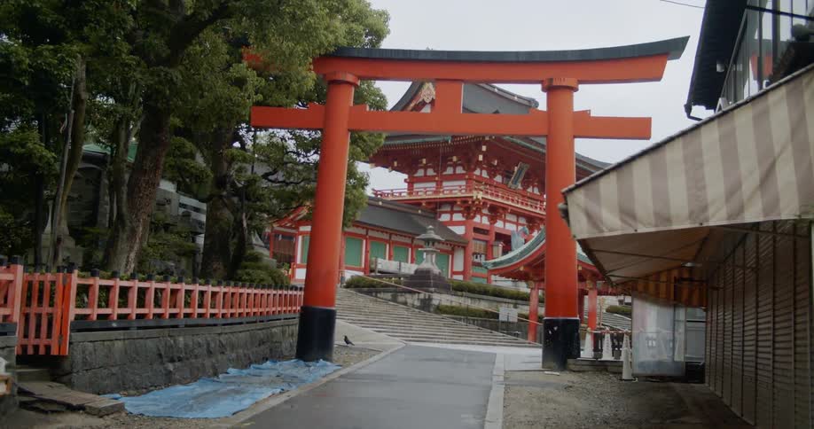 Orange pillar archway near buildings in a foreign land