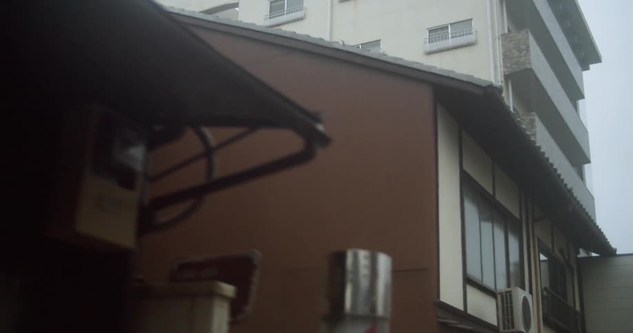 A person walks by city buildings