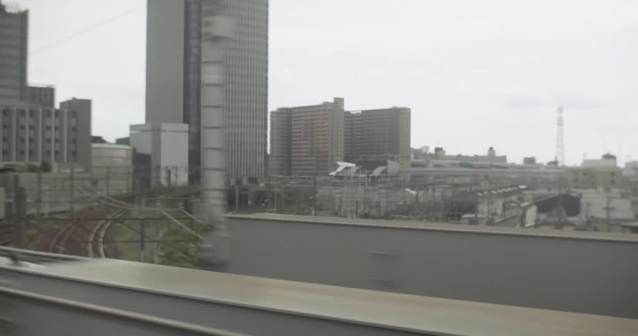 Train travels down the track in the city