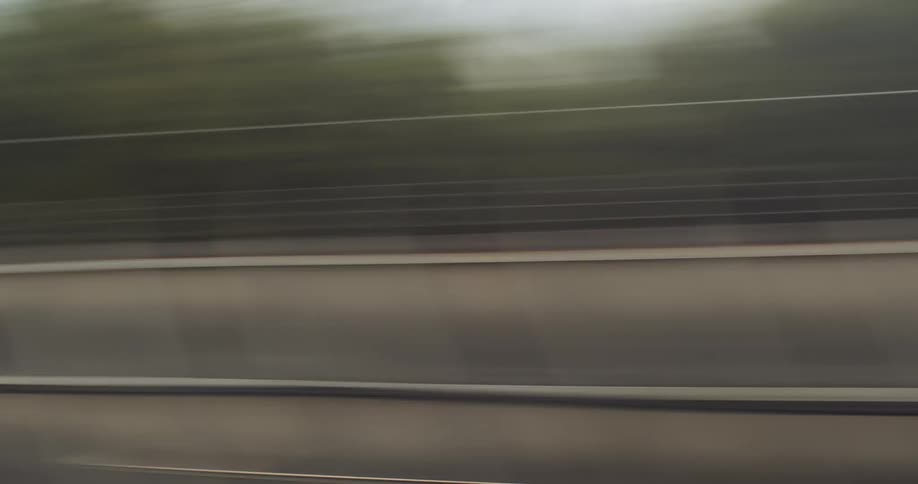 The hills and town are a blur as it is passed