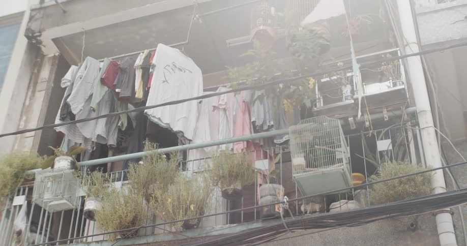 Clothes hang on a line on a balcony on a sunny day