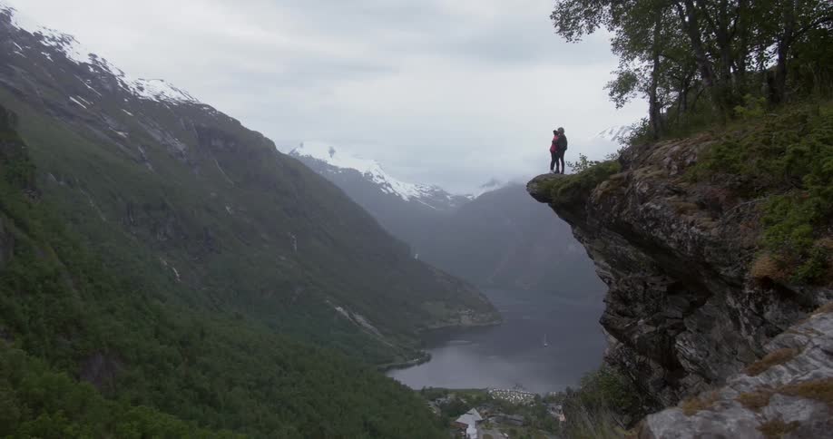 A person standing on a cliff edge