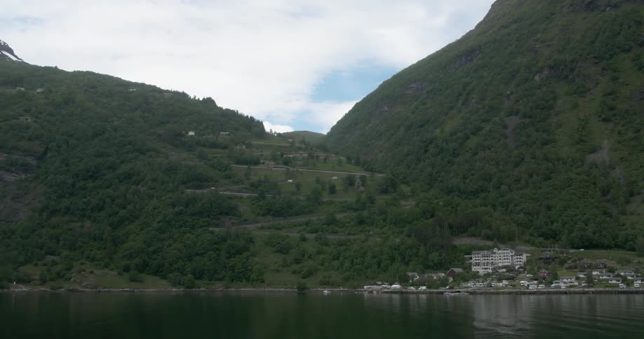 A coastal town near a mountain in the daytime