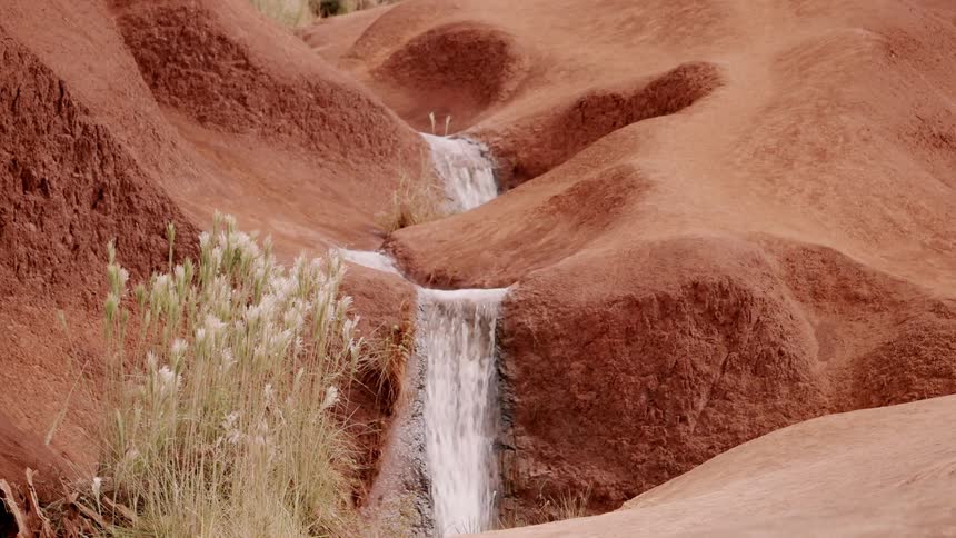 Waterfall splashes through a rocky landscape