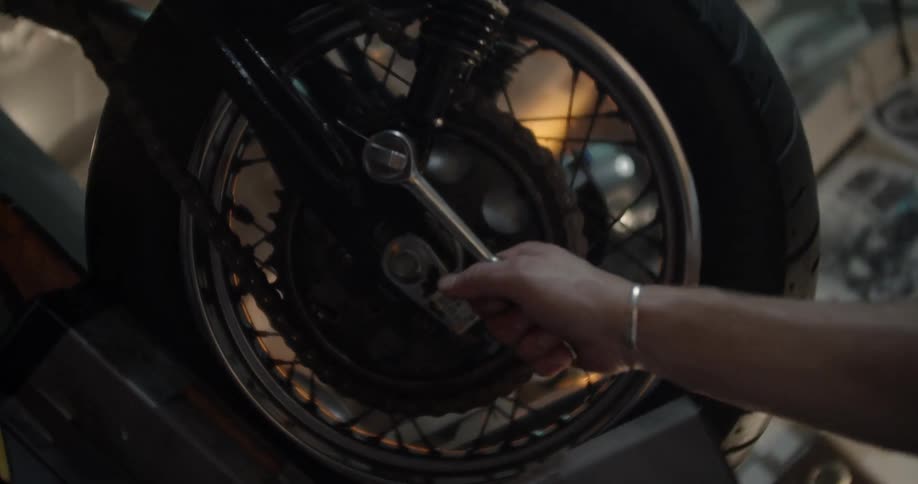Man tightens a bolt on a bike