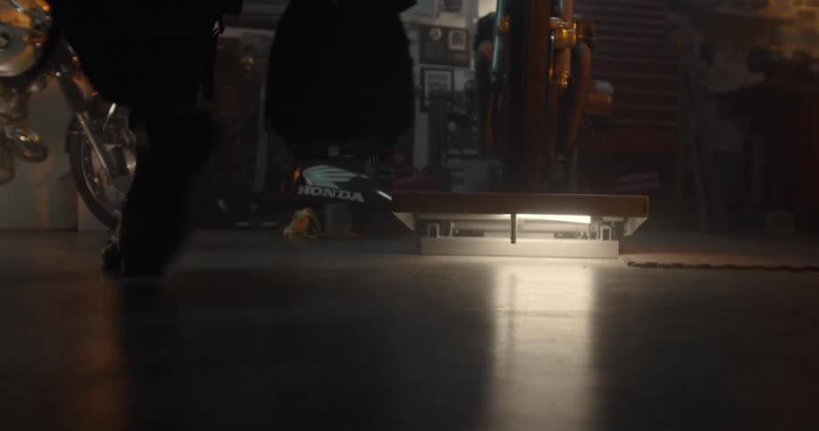 A man carries a bag into a garage