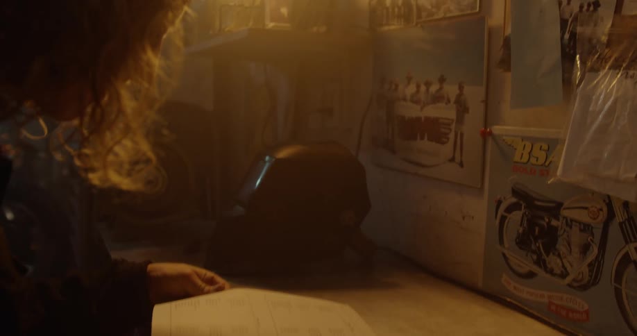 A person reads an instruction manual at a workbench