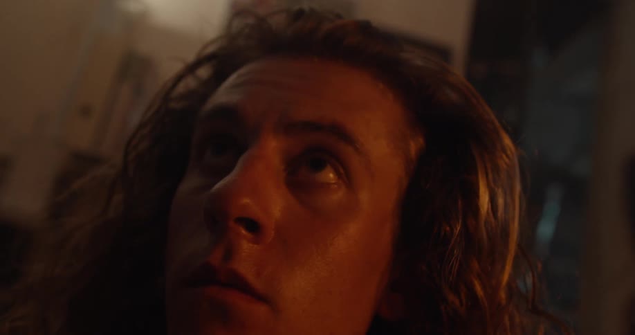 A man looks around in a dark room