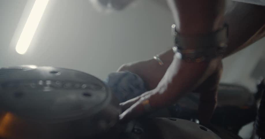Man Working On Motorcycle In Garage