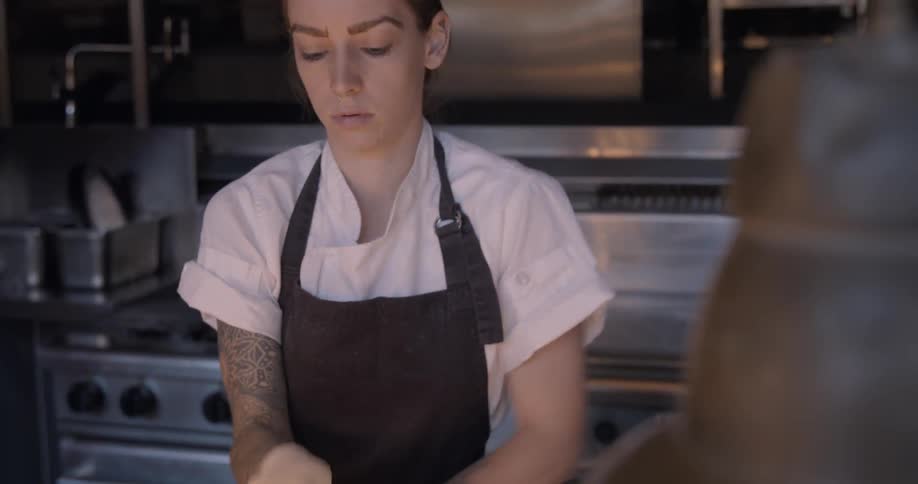A chef makes pizza dough in a kitchen