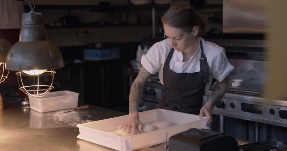 A chef is preparing food in the kitchen