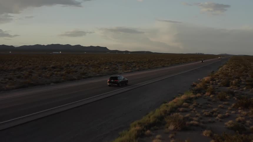 Cars travel on a desert road