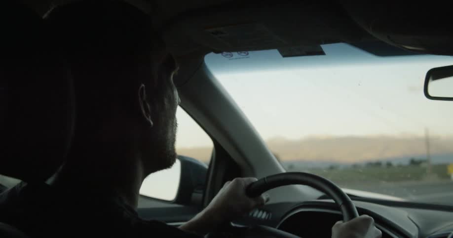 Man drives a car through the country