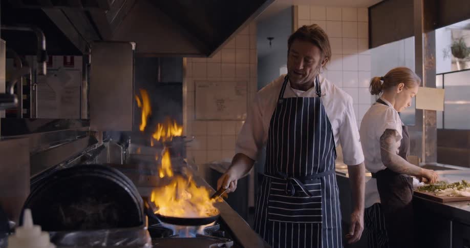 Two chefs are cooking in the kitchen