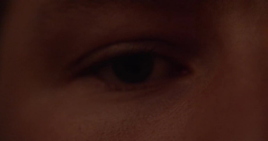 A person looks around in the dark
